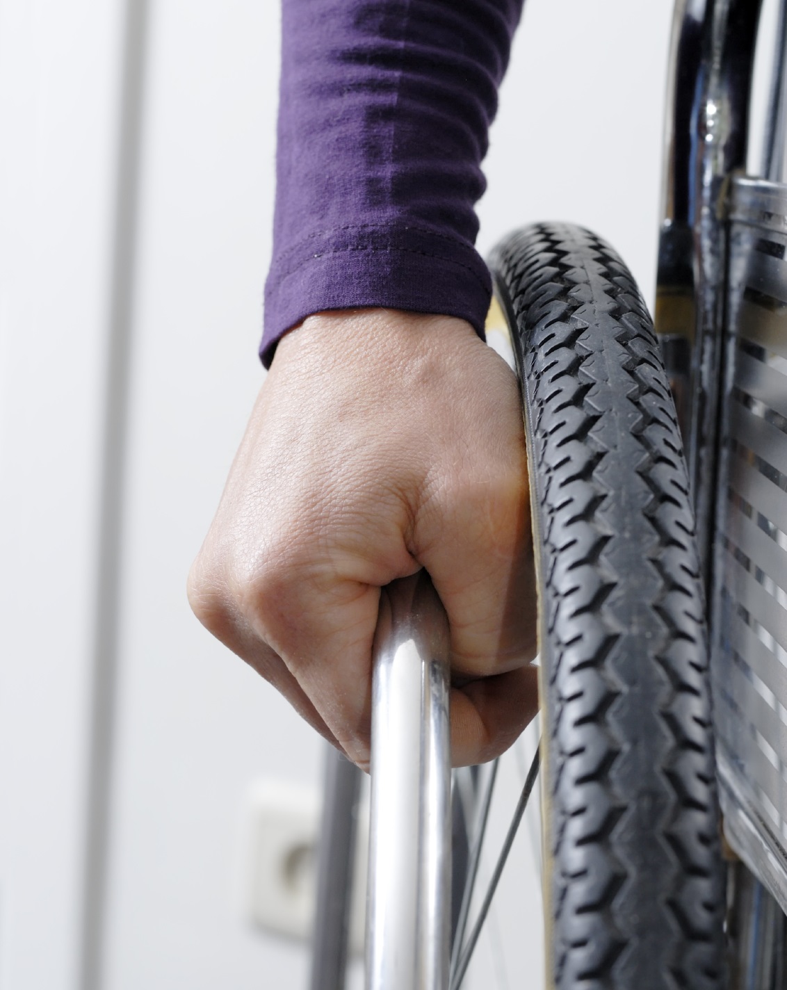Hand on a wheelchair wheel